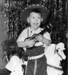 Photo of George Seccombe at age four playing guitar